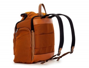Travel backpack with flap in orange lateral